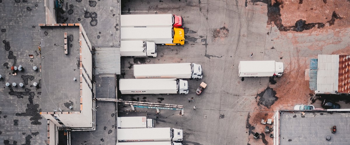Aerial view of trucks parked at loading bays of a warehouse